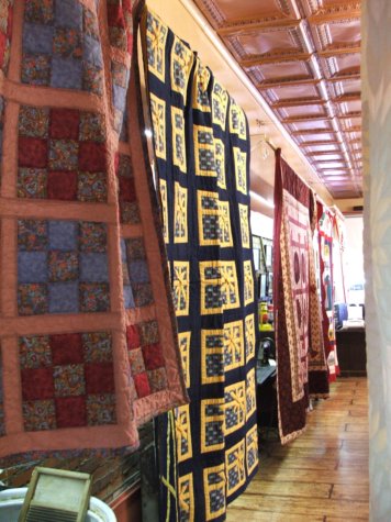 Quilts displayed in a quilt shop startup business shop.